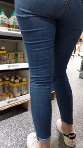 Brunette girl with nice ass sexy PAWG in tight jeans in a store