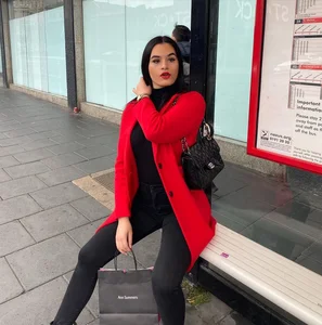 Hot Girl in Tight Pants Sitting on a Bench at a Bus Stop
