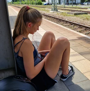 A Hot Candid Girl in Mini-Shorts And Sneakers Sitting on the Floor at the Railway Station Creepshots Gallery