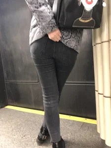 Girl in Tight Black Jeans Standing with Crossed Legs Closeup Candid