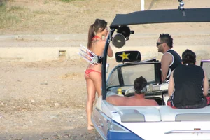 Brunette on a boat in red thong bikini with a tight little ass