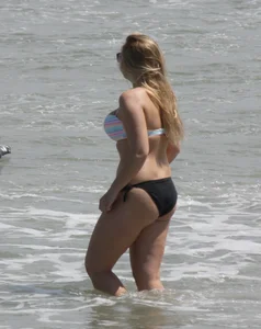 Big boobed thick blonde on the beach in a bikini