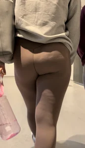 Tall curlyhead college girl in skin coloured leggings