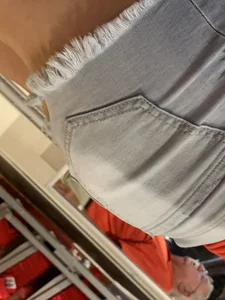 Bunch of girls in various outfits at a Cardinals baseball game