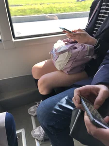 A Very Cute And Skinny Candid Teen Girl Wearing Glasses, A Skirt And Knee Socks Sitting in a Public Bus, Closeups of Her Legs