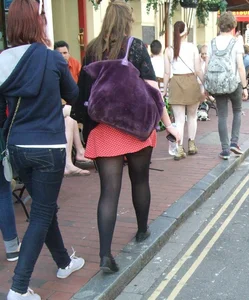 Girl in a pink skirt and stockings accidentally showing some cheek