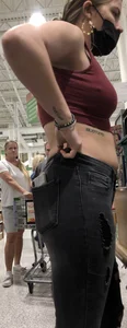 Latina in Maroon crop top and tight black jeans