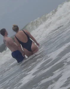 Thick blonde on the beach with a big booty in a blue swimsuit