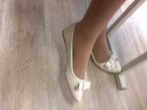 Closeup of a College Teen’s Feet in Pantyhose And White Shoes Under Desk Creepshot