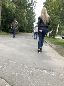 Young Blonde Girl in Tight Blue Jeans Scratching Her Booty While Passing By on the Suburban Street Creepshots Gallery