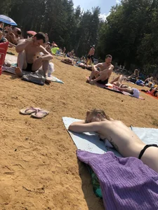 Topless Skinny Girl With Very Pale Skin Lying on a Beach on Her Tummy With Slightly Spread Legs Creepshots Gallery