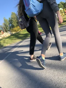 Skinny Girl in Grey Leggings Walking Past the Camera Candid Photos Gallery