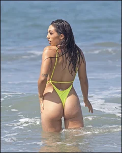 Sexy ass beach babe in a yellow thong swimsuit