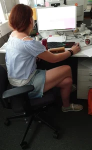 Ginger Girl in a Jean Skirt Sitting at Her Desk With Crossed Legs Office Creepshot