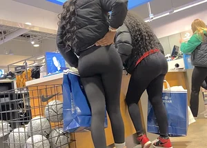 Two ebony girls in leggings at the register