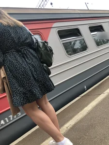 Hot candid girl wearing a dress on a train station platform