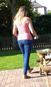 Girl wearing tight blue jeans in the backyard creepshots