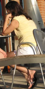 Lady in flop flops while eating showing her feet