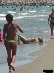 Bunch of sexy babes at the beach in thong bikinis