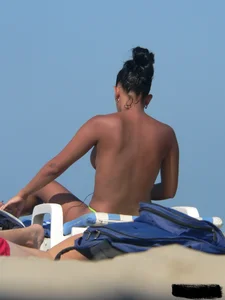 Hot ass topless beach girl with great tits lets her little brother oil up her ass in thong bikini