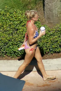 Blonde babe at the pool with sexy body in USA bikini