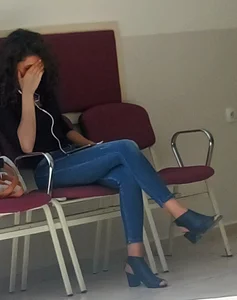 A Skinny Girl in Shoes With Heels And Tight Blue Jeans Sitting With Crossed Legs, Creepshot at the Public Library