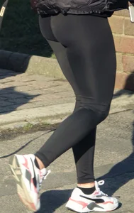 Pouting brunette teen in black leggings