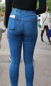 Brunette beauty with a slender waist in tight jeans