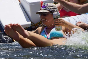 Sexy party girls in bikinis on a lake