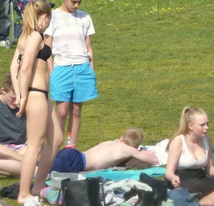Teen taking off her dress in the park