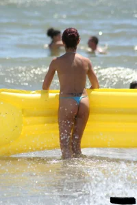 Blue thong lady in the water with a float