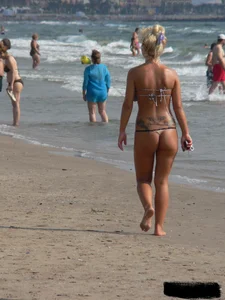Tattooed blonde with big tits topless and in thong