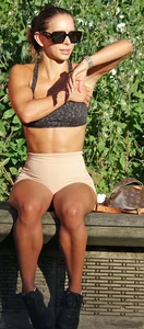 Tanned fitness woman showing off her toned physique & amazing butt