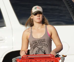 Hot blonde after shopping in short jean shorts and tank top