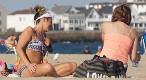 Beach babe in a blue bikini with thick friend in shorts