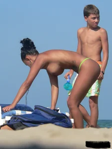 Hot ass topless beach girl with great tits lets her little brother oil up her ass in thong bikini
