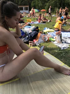 Sexy Girl in Swimsuit Sitting on a Beach With Her Phone Creepshots Gallery