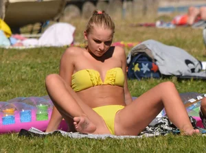 Blonde looking sexy in a yellow bikin
