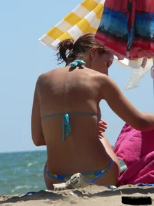 A bunch of hot babes on the beach in thong bikinis
