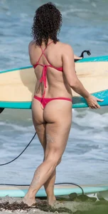 Thick brunette milf on the beach in red thong bikini