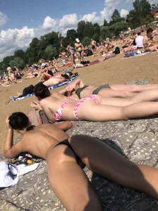 Gorgeous milf rubbing sun lotion in her skin at the beach, with a couple of her milf friends