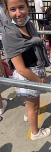 Teen with braces waiting in line for a ride