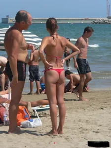 A bunch of hot babes on the beach in thong bikinis