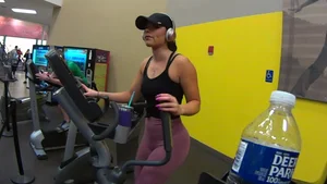 Smoking hot brunette working out at the gym in tight leggings