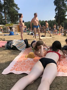 Pale Girl in Swimsuit Lying on a Lake Beach With Her Friends Creepshots Gallery