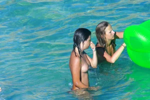FKK Nudists playing in the water with floater