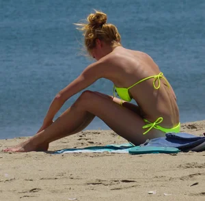 Sexy ass blonde milf on the beach in a thong with cameltoe and bending over
