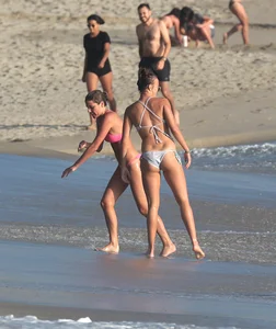 Two sexy friends out on the beach in bikinis