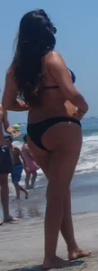 Thick brunette beach babe booty in a little black bikini