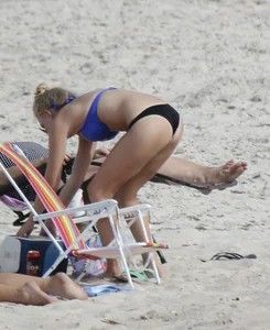 Florida blonde in blue and black bikini on the beach